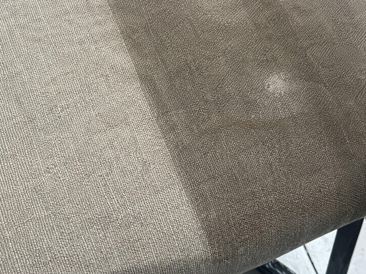 Upholstery fabric showing a cleaned area beside a stained area