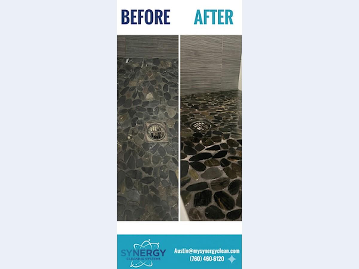 Before-and-after restoration of a black river-rock pebble mosaic shower floor