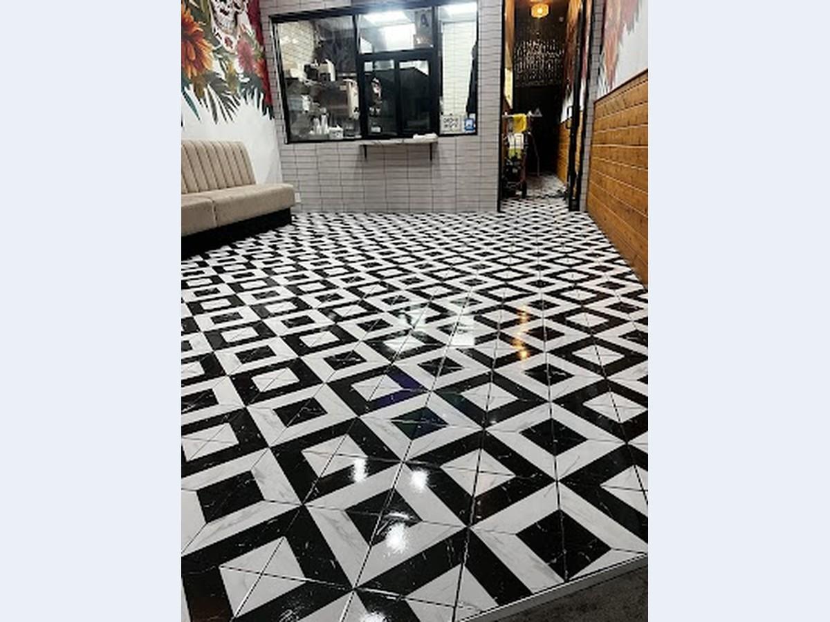 Glossy black-and-white restaurant floor after professional cleaning and buffing